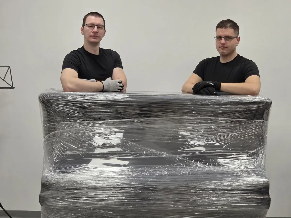 Das FlexiTrans-Team trägt ein verpacktes Klavier
